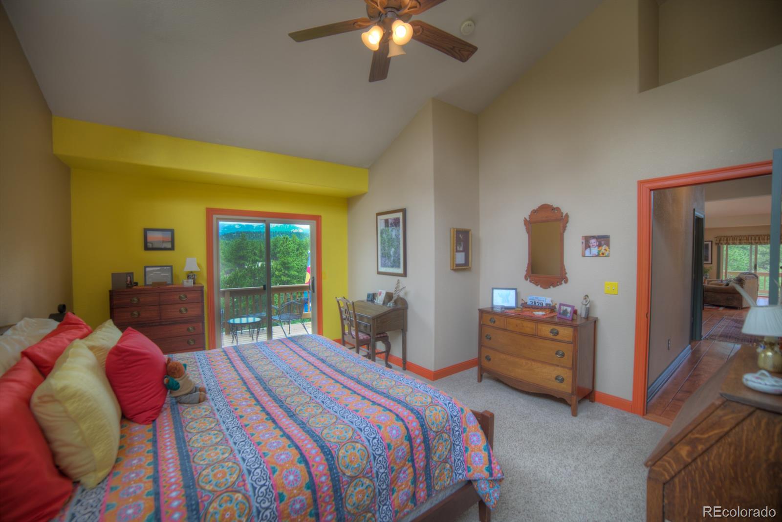 264 Hangmans Road Bailey, CO 80421 - Photo 17 of 33 a bedroom with a bed and a chandelier