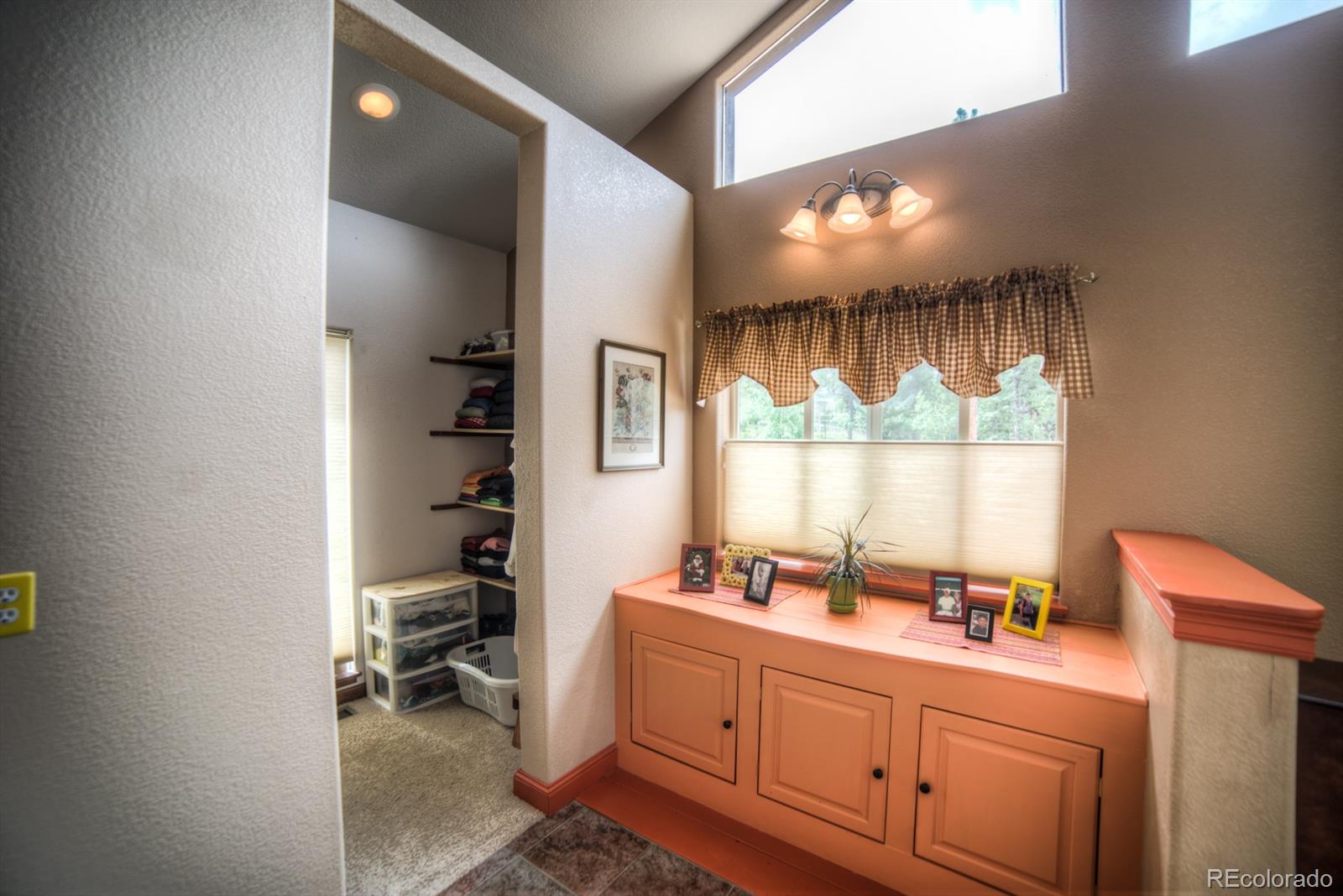 264 Hangmans Road Bailey, CO 80421 - Photo 19 of 33 a bathroom with a sink mirror and window