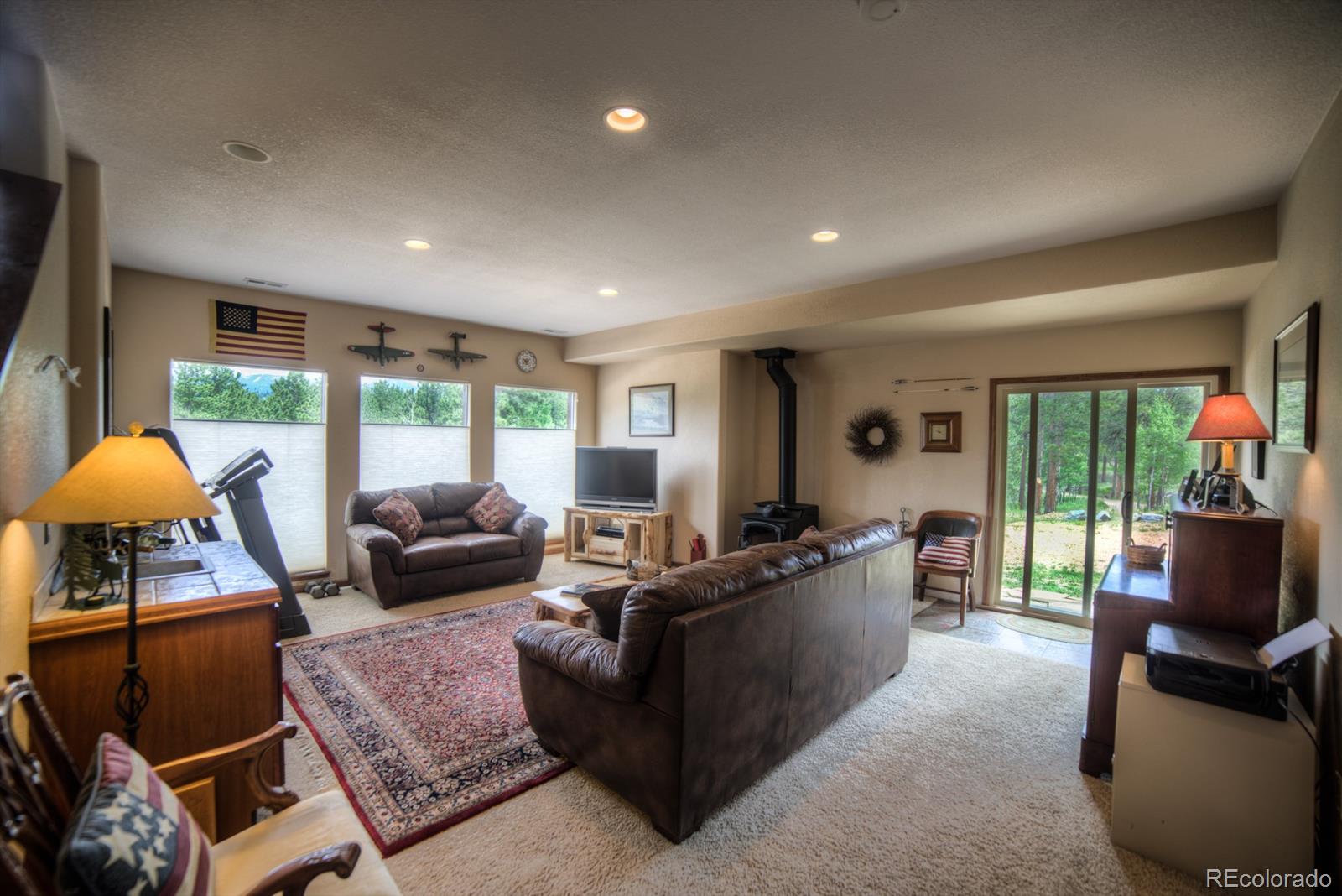 264 Hangmans Road Bailey, CO 80421 - Photo 21 of 33 a living room with furniture a fireplace and a large window