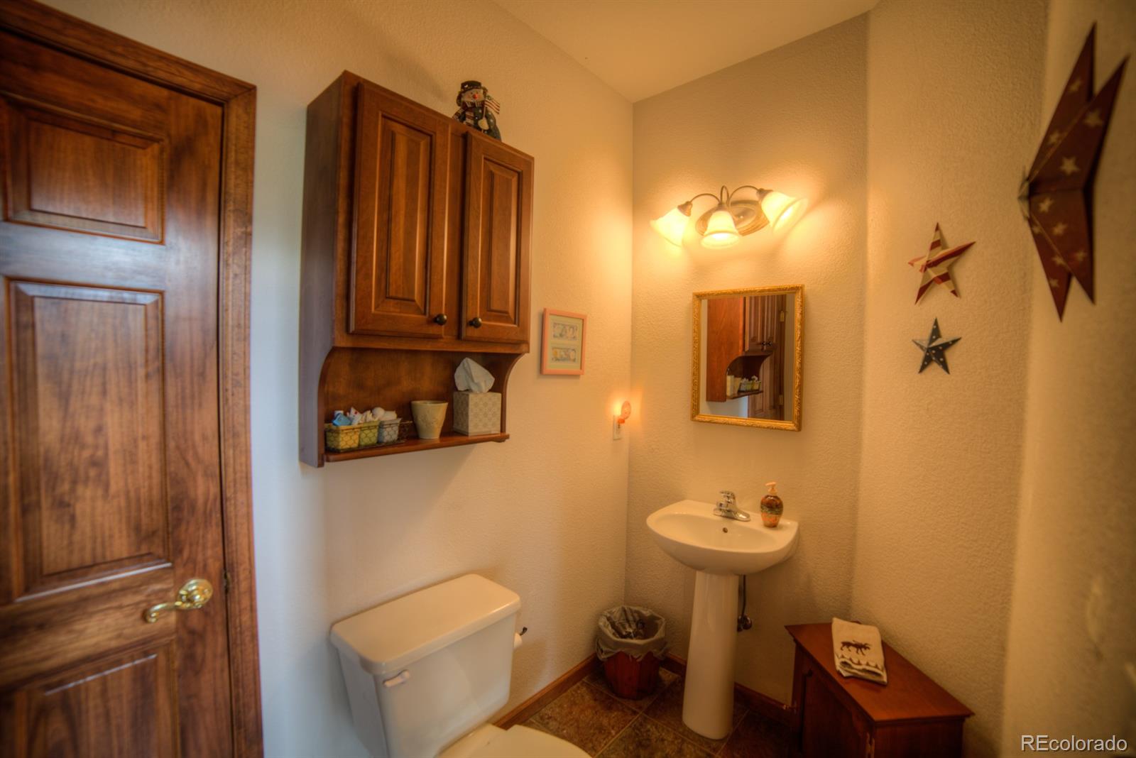 264 Hangmans Road Bailey, CO 80421 - Photo 24 of 33 a bathroom with a sink mirror and toilet