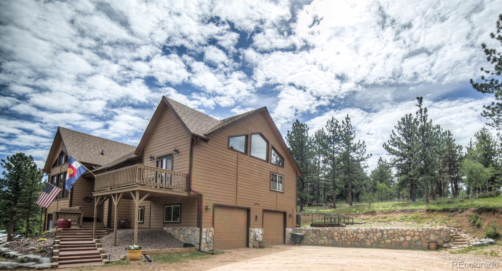 264 Hangmans Road Bailey, CO 80421 - Photo 3 of 33 a front view of a house with a yard