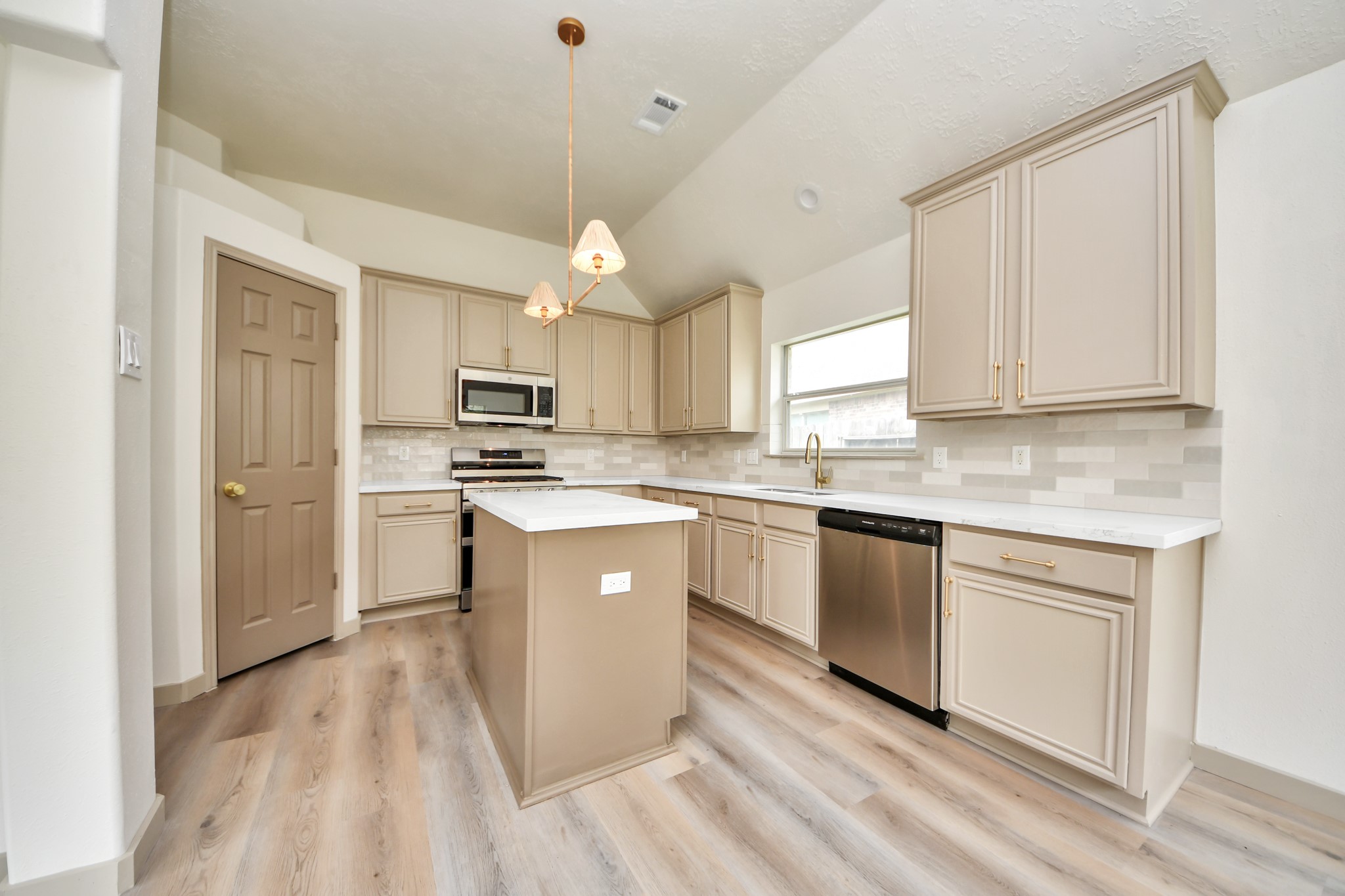 14423 Gadwall Court Houston, TX 77044 - Photo 26 of 42 a kitchen with cabinets stainless steel appliances a sink and a window