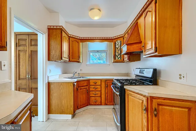 a utility room with mirror and a sink