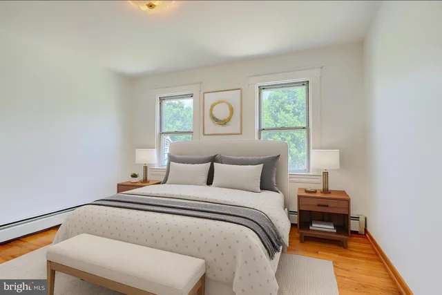 a bathroom with a tub a sink and a window