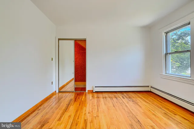 a living room with furniture and a dining table