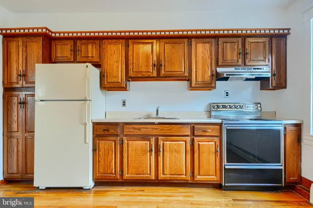 an aerial view of residential houses with outdoor space and swimming pool