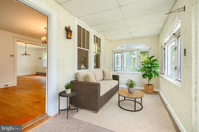 a view of hallway with furniture and a window