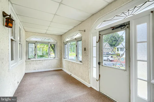 a view of an empty room and a window