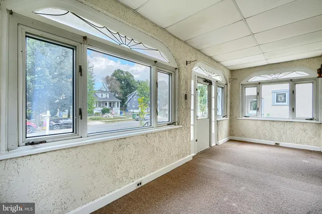 a view of a room with wooden floor and staircase