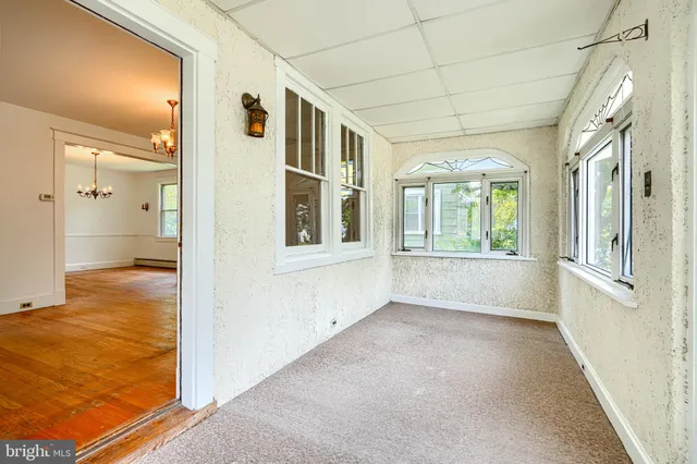 a living room with furniture a chandelier and a window