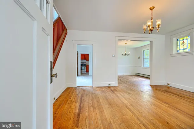 a view of livingroom with hardwood floor and kitchen