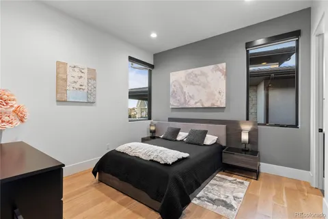 a bedroom with a bed and wooden floor