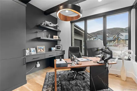 a living room with furniture kitchen view and a large window