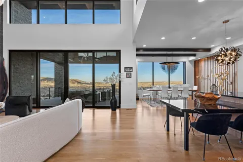 a dining room with furniture and a floor to ceiling window