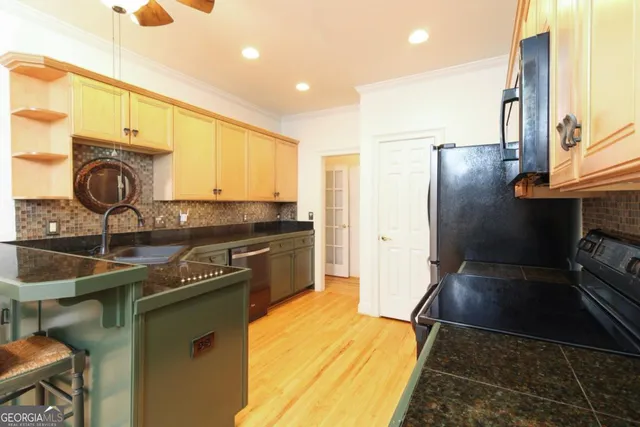 a kitchen with a sink appliances and cabinets