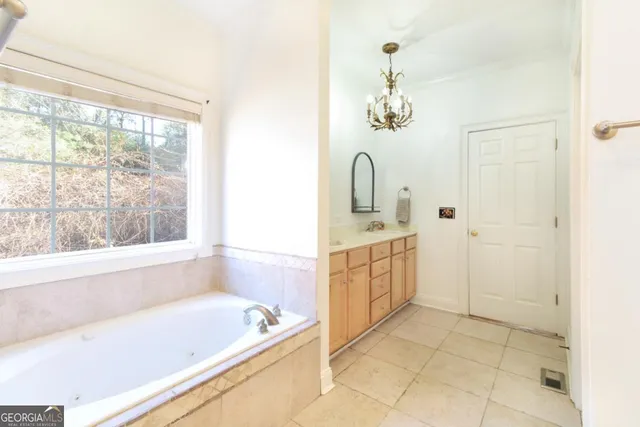 a bathroom with a tub sink and window