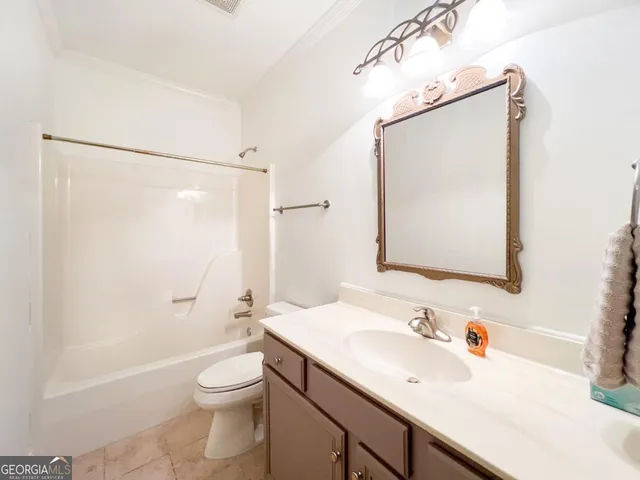 a bathroom with a sink vanity mirror and toilet