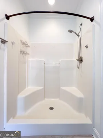 a bathroom with a shower and a bath tub