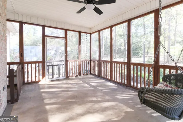 a view of a porch with wooden floor and a balcony