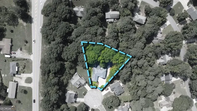 an aerial view of a house with outdoor space