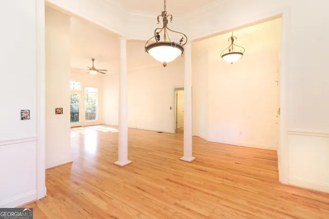 a view of a room with wooden floor and window