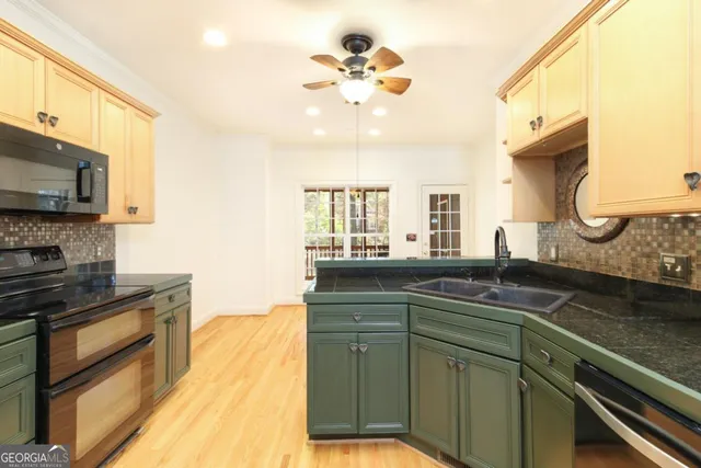 a kitchen with a sink stove and microwave