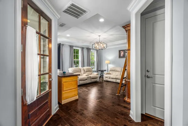 a living room with furniture and a chandelier