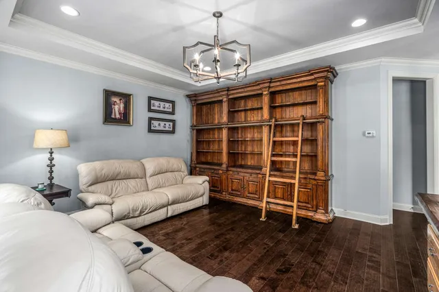 a living room with furniture and a chandelier