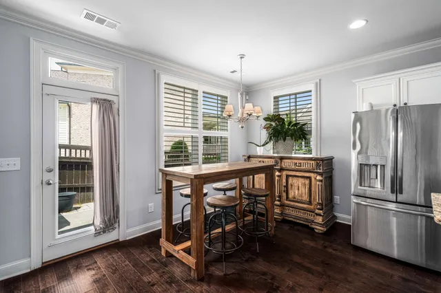 a open kitchen with stainless steel appliances granite countertop a refrigerator and a stove top oven