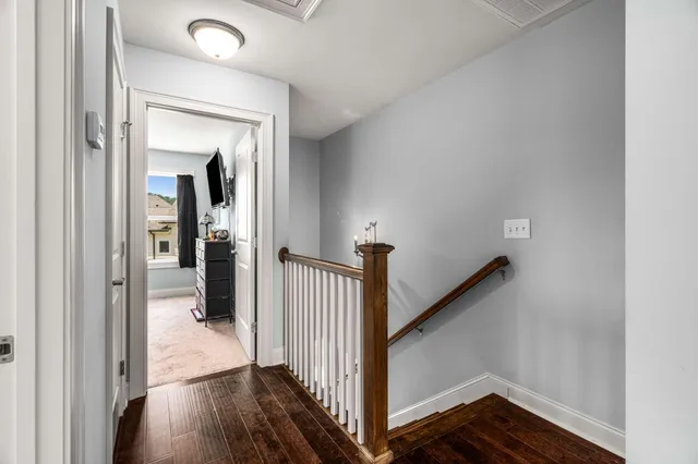 a view of a hallway view with wooden floor and staircase