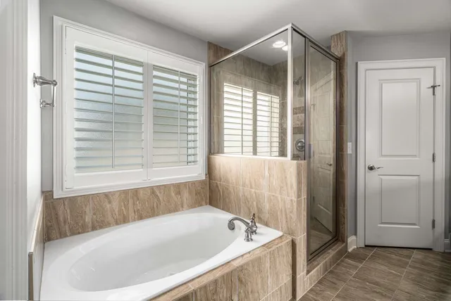 a bathroom with a bathtub and shower