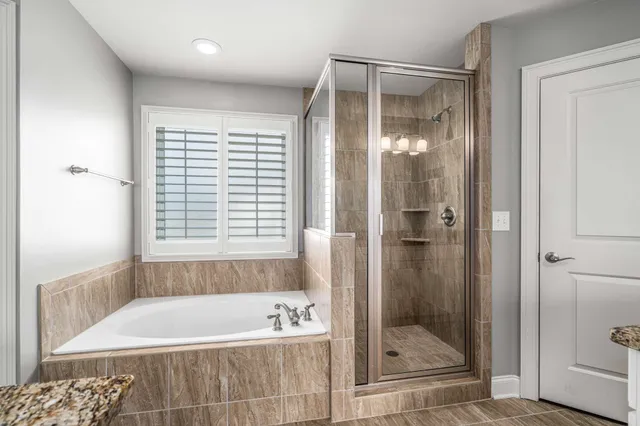 a bathroom with a bathtub and a shower