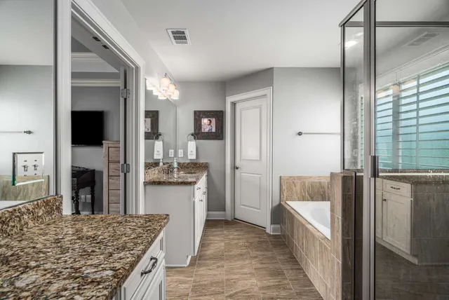 a living room with stainless steel appliances granite countertop furniture and a fireplace