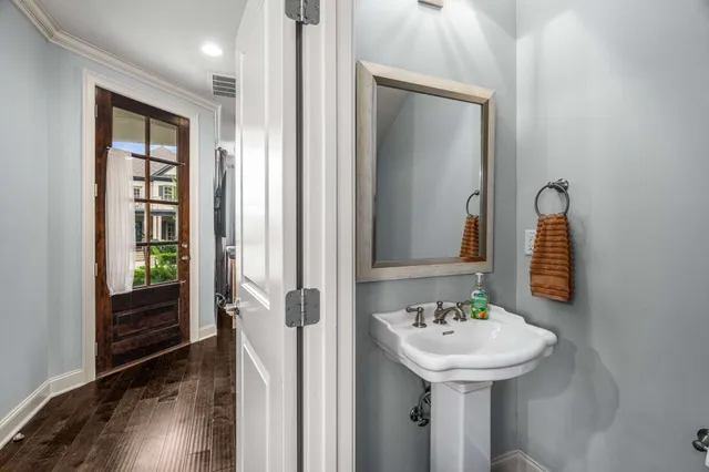 a bathroom with a sink a toilet and a mirror