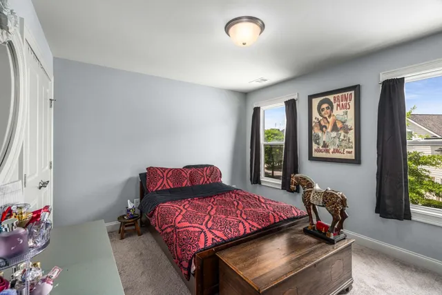 a bedroom with furniture and a window