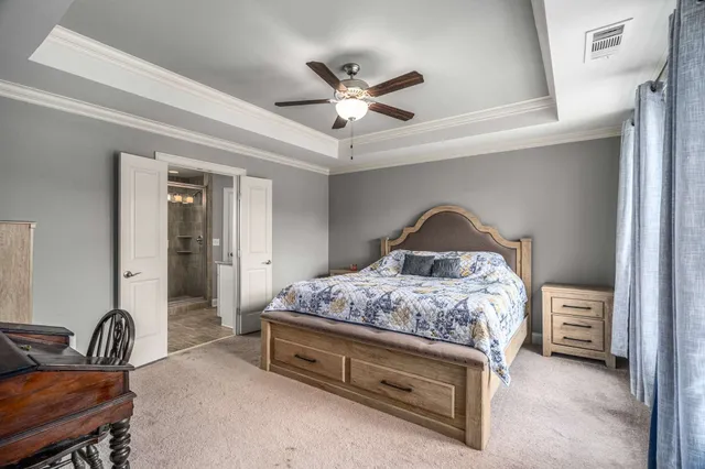 a bedroom with a bed and a chandelier