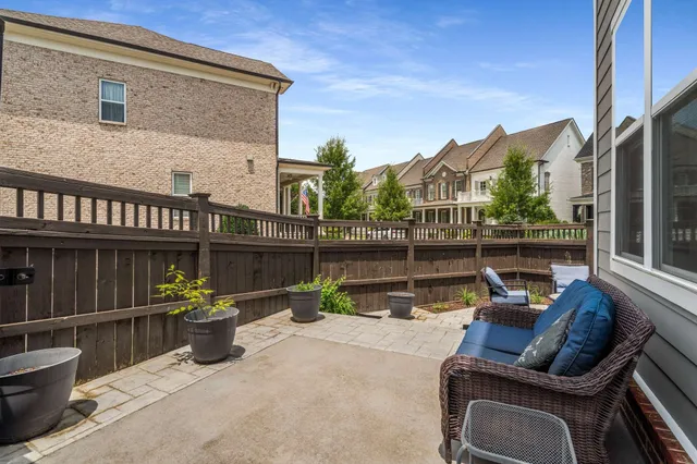 a view of a chair and tables in the balcony