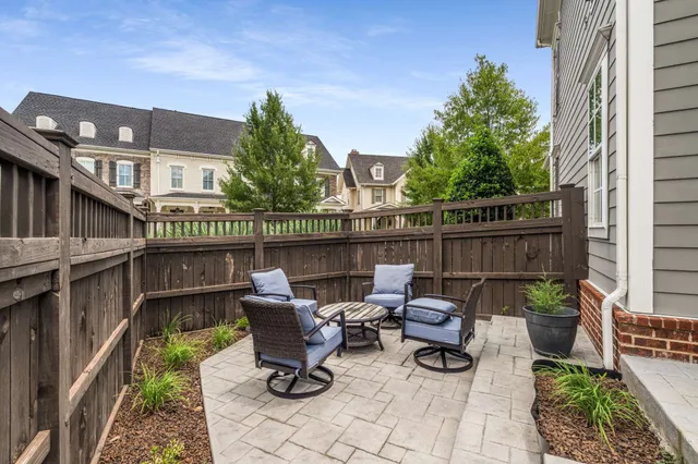 a view of a patio with chairs and a table