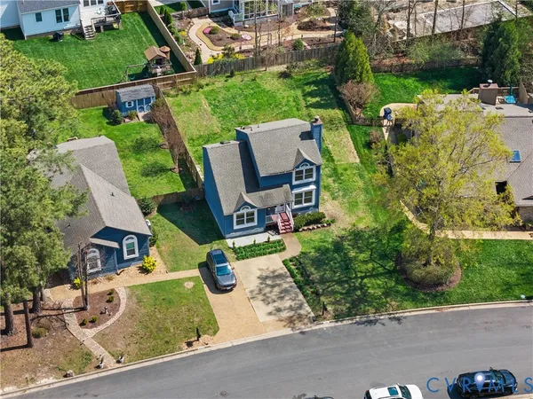 an aerial view of a house with garden space and street view