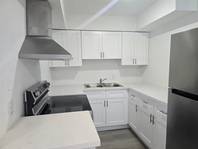 a kitchen with a sink a stove and cabinets