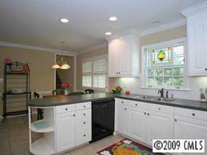 3108 Clarendon Road Charlotte, NC 28211 - Photo 4 of 8 a kitchen with a sink window and cabinets