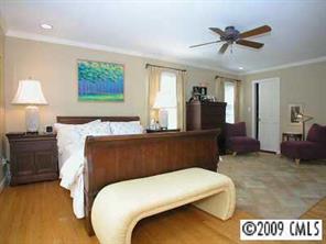 3108 Clarendon Road Charlotte, NC 28211 - Photo 6 of 8 a bedroom with a bed and a chandelier