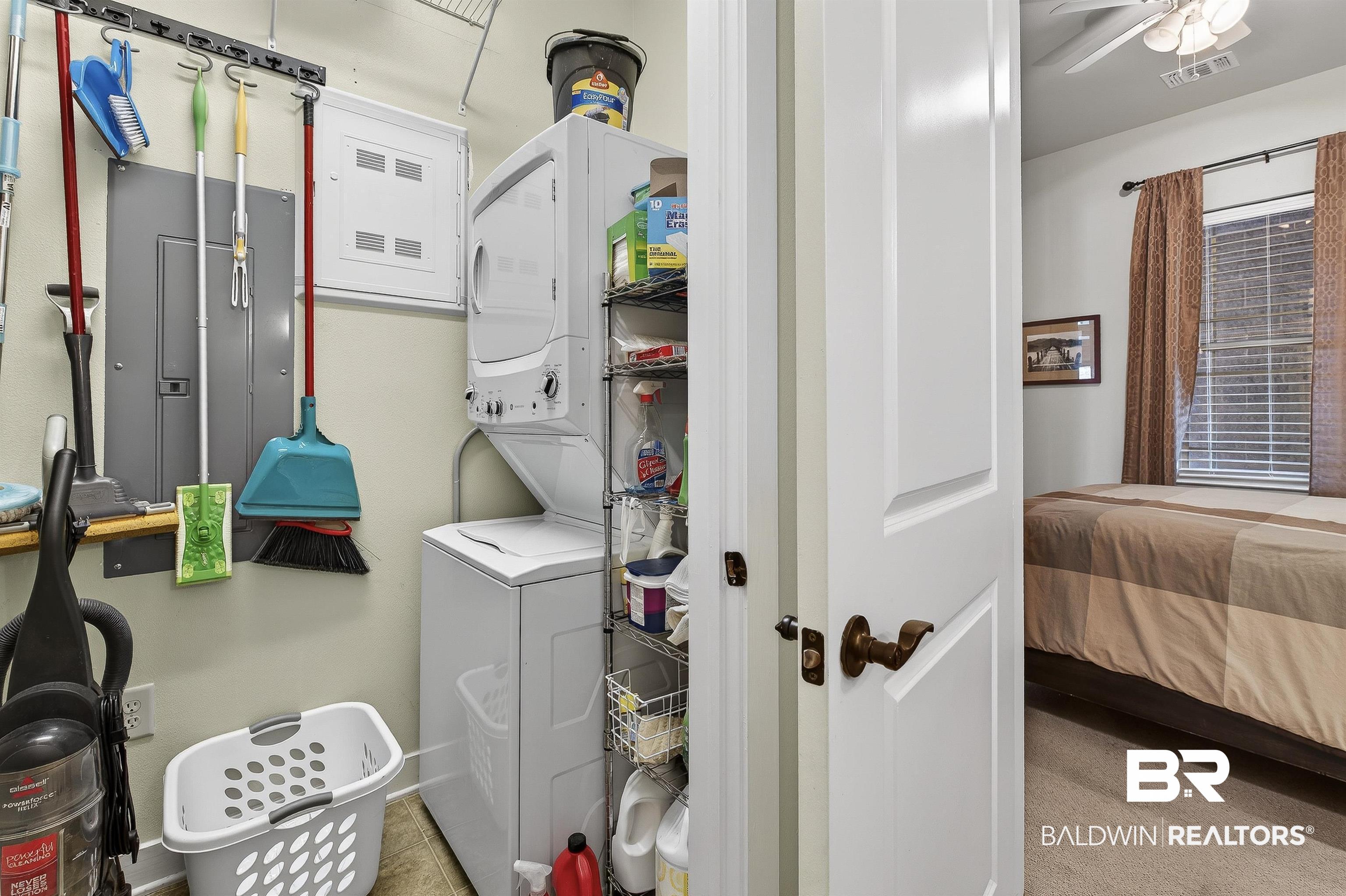 1430 West Regency Road, Unit I102 Gulf Shores, AL 36542 - Photo 22 of 31 Laundry area with stacked washer / dryer, ceiling fan, and electric panel