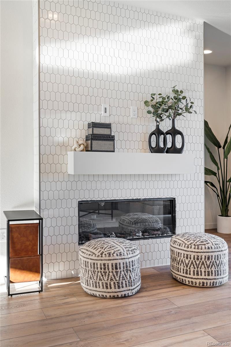 10884 Lyric Street Lone Tree, CO 80134 - Photo 2 of 8 a living room with furniture and a fireplace