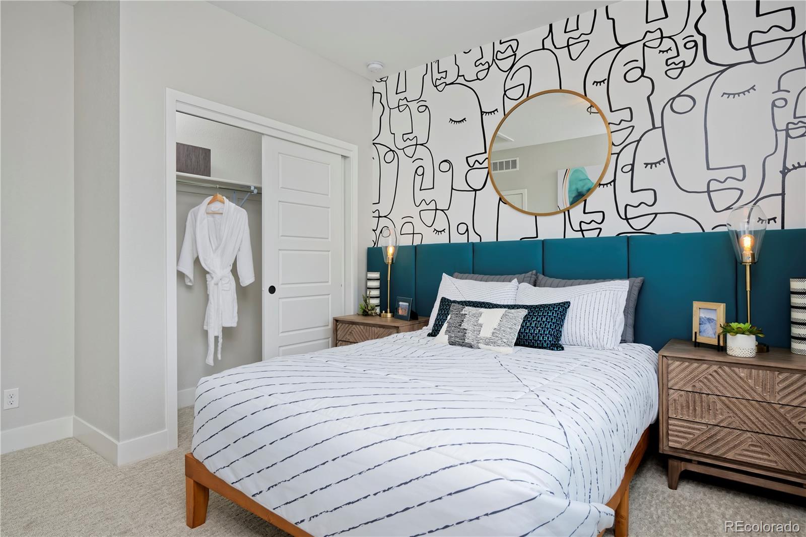 10884 Lyric Street Lone Tree, CO 80134 - Photo 3 of 8 a bedroom with a bed and a chandelier