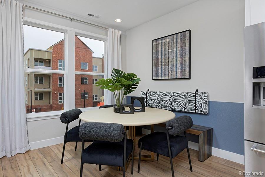 10884 Lyric Street Lone Tree, CO 80134 - Photo 5 of 8 a dining room with furniture and wooden floor