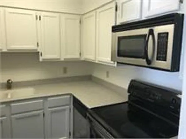 a kitchen with a sink and a microwave