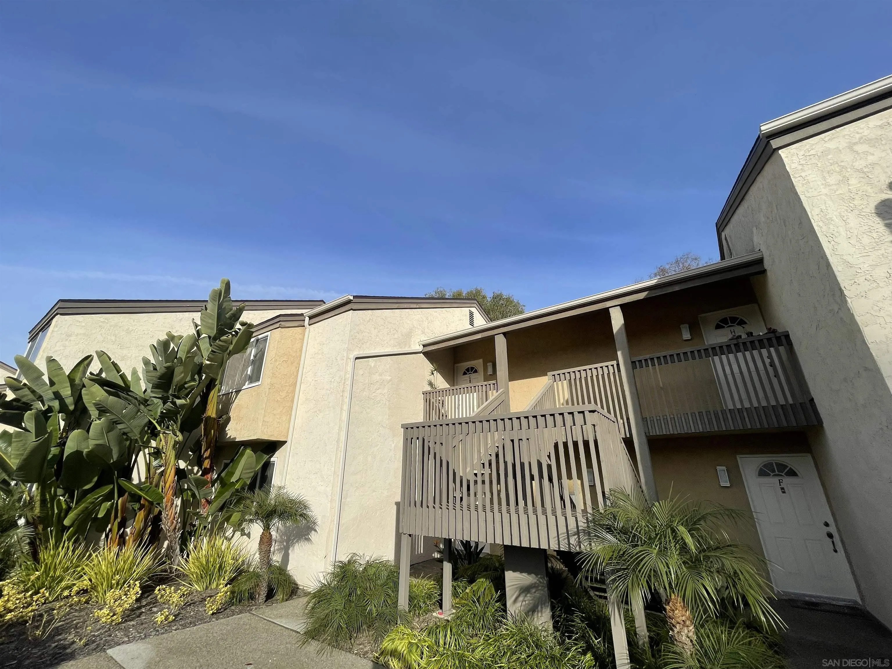 8520 Via Mallorca, Unit K La Jolla, CA 92037 - Photo 2 of 12 a roof deck with table and potted plants