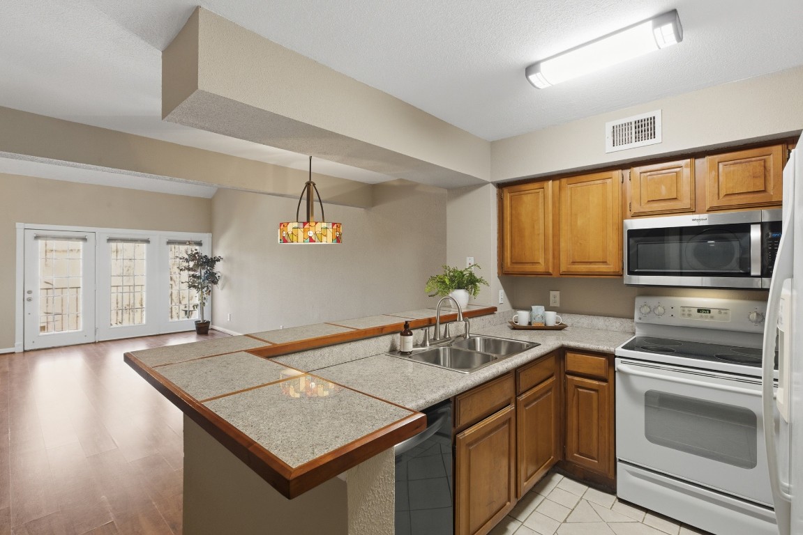 2425 Holly Hall Street, Unit 100 Houston, TX 77054 - Photo 17 of 45 Well appointed kitchen overlooking living and dining areas.