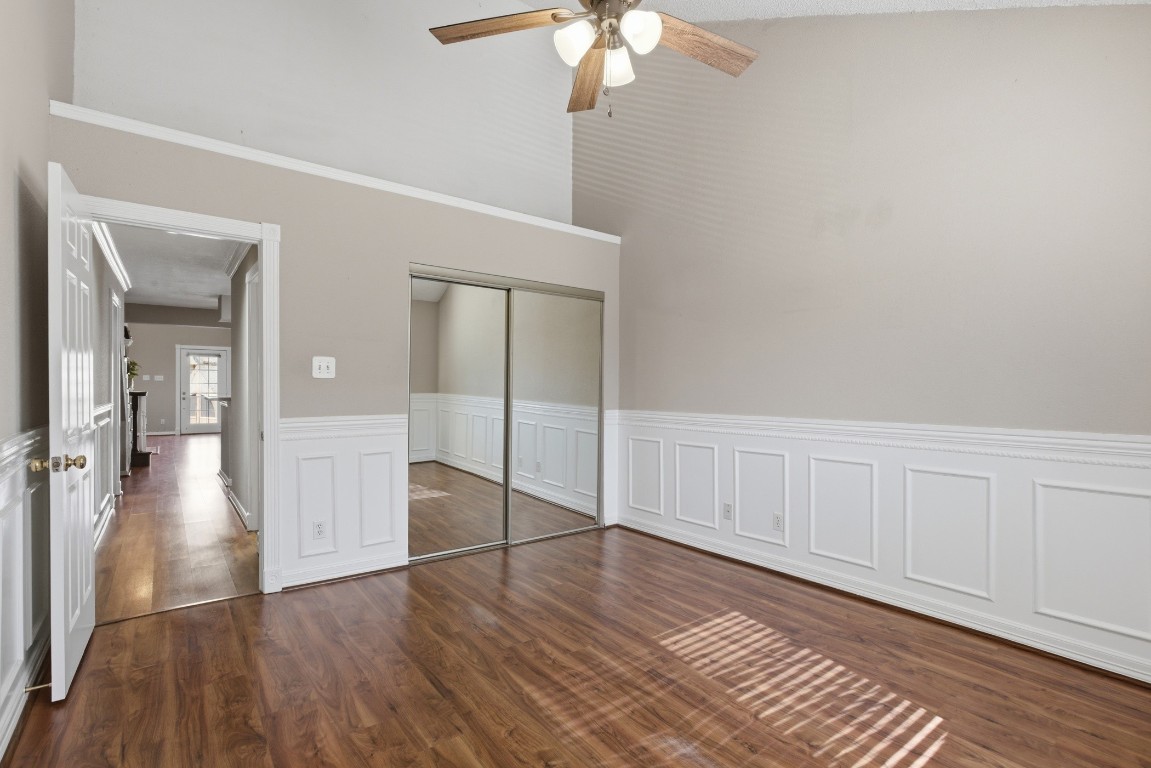 2425 Holly Hall Street, Unit 100 Houston, TX 77054 - Photo 25 of 45 Primary bedroom with lovely wainscoting, neutral paint and large closet, plus additional area above for storage or decor.